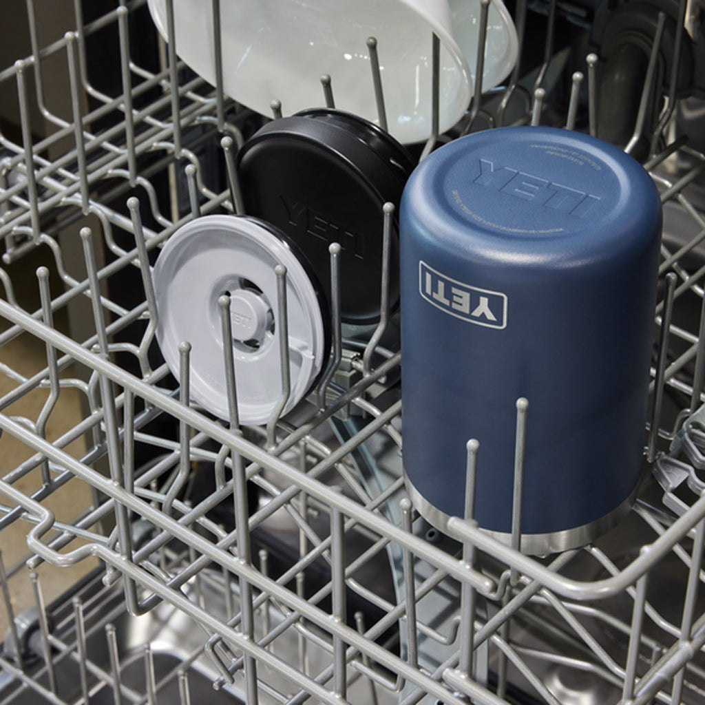 Blue YETI food jar in a dishwasher rack with other items.